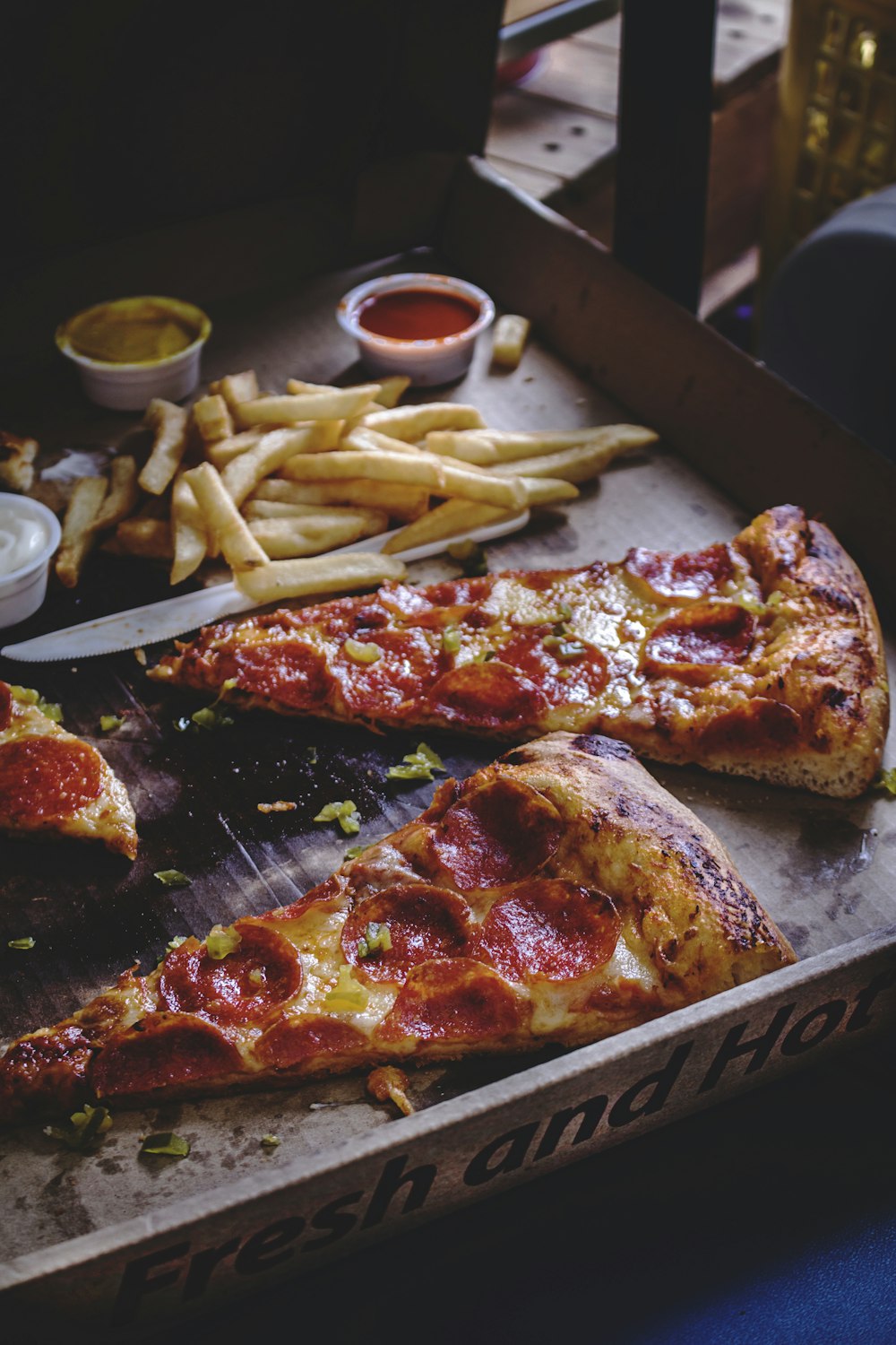 baked pepperoni pizza with French fries