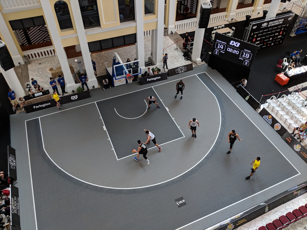 man playing basketball on gray court