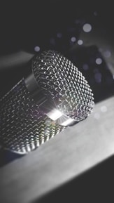 Close-up of a microphone with colorful glass effect reflections in a creative studio.