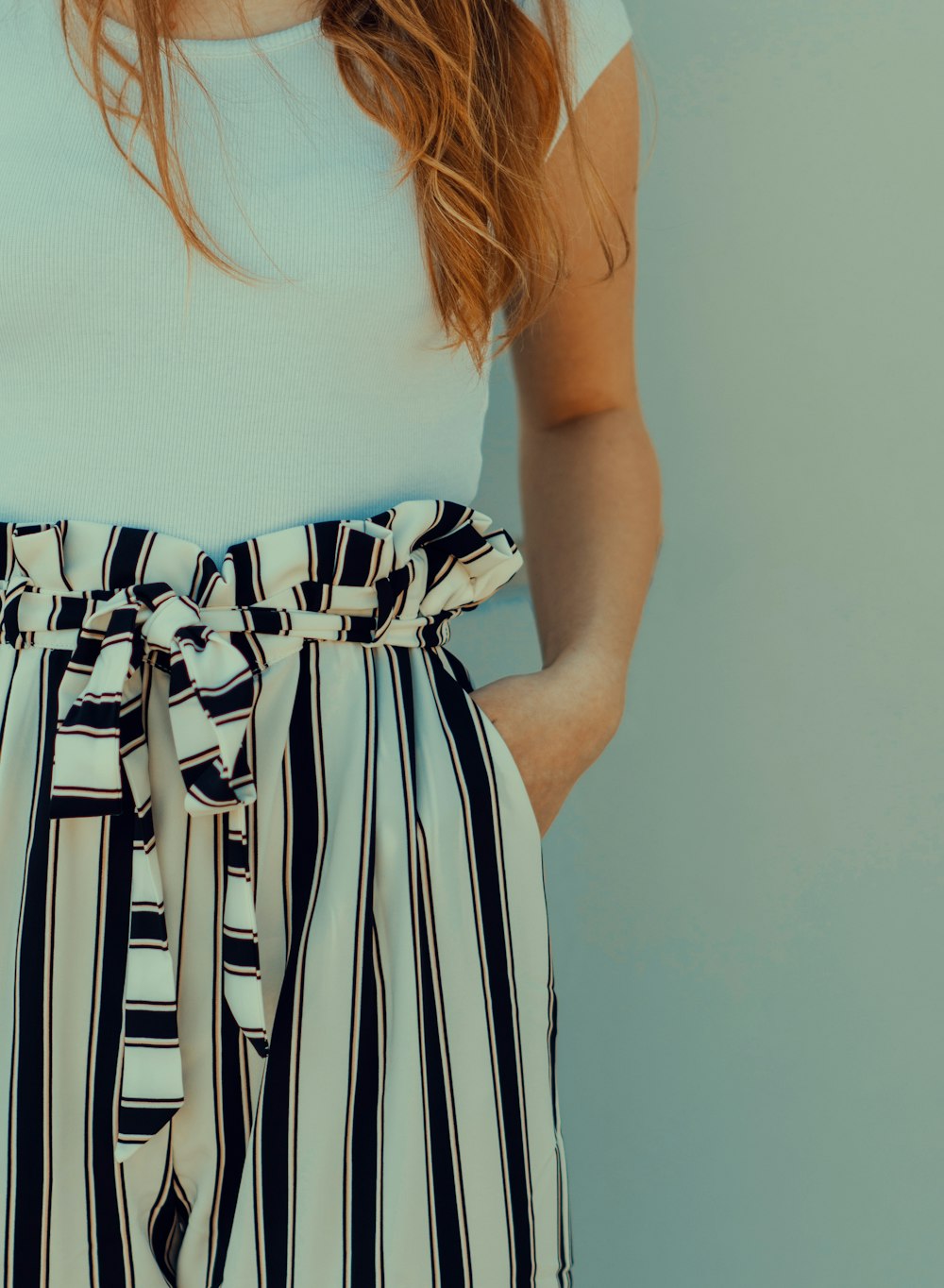 woman standing beside wall