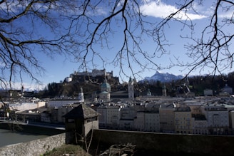 A scenic view of Edinburgh with a travel suitcase in the foreground.
