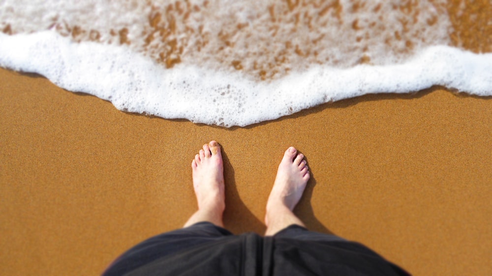 person standing at the edge of the shore