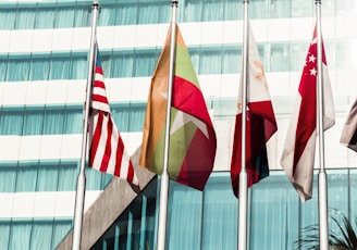 several country flags near to glass building