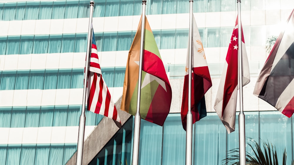 several country flags near to glass building