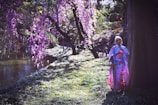 A stylish Japanese man wearing a modern kimono in a serene garden.