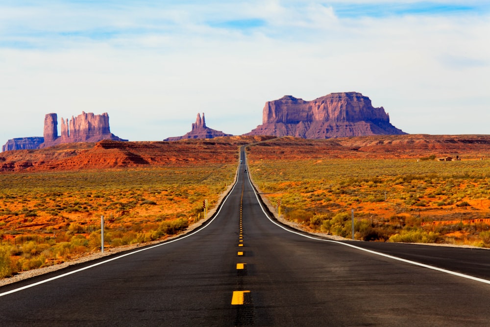 asphalt road in the middle of the desert