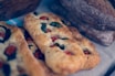 An inviting close-up of freshly baked gluten-free breads displayed on a wooden table.