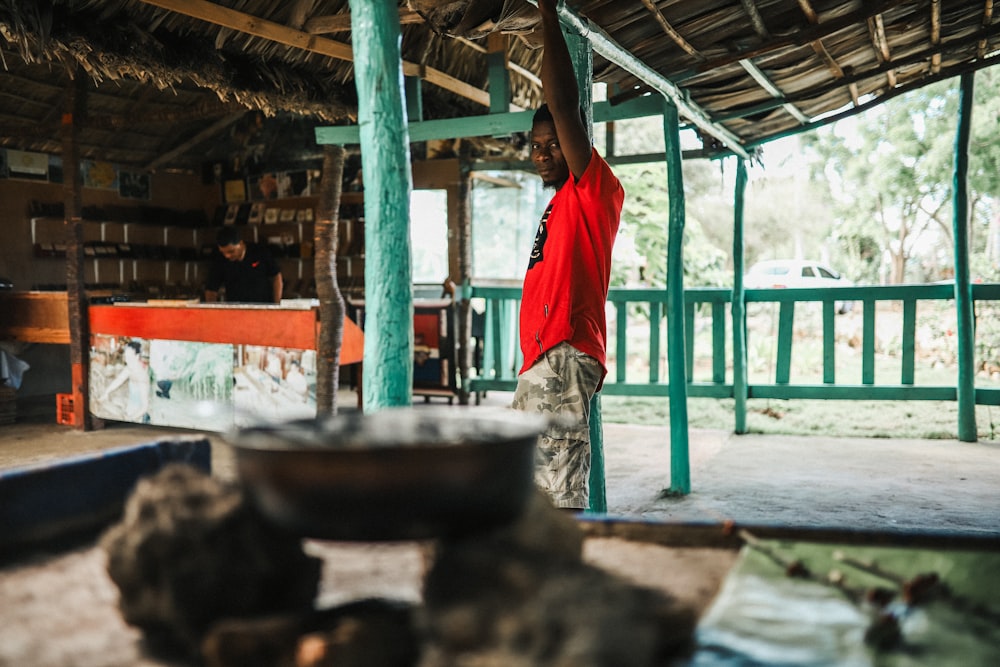 man standing near post