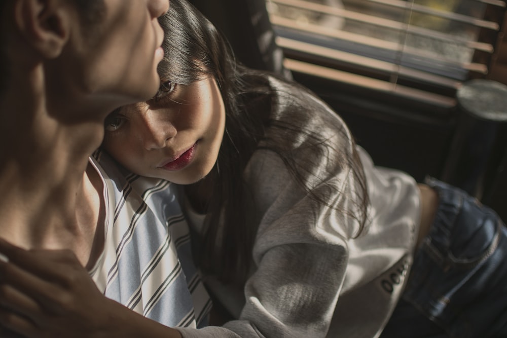 girl hugging man inside dark room