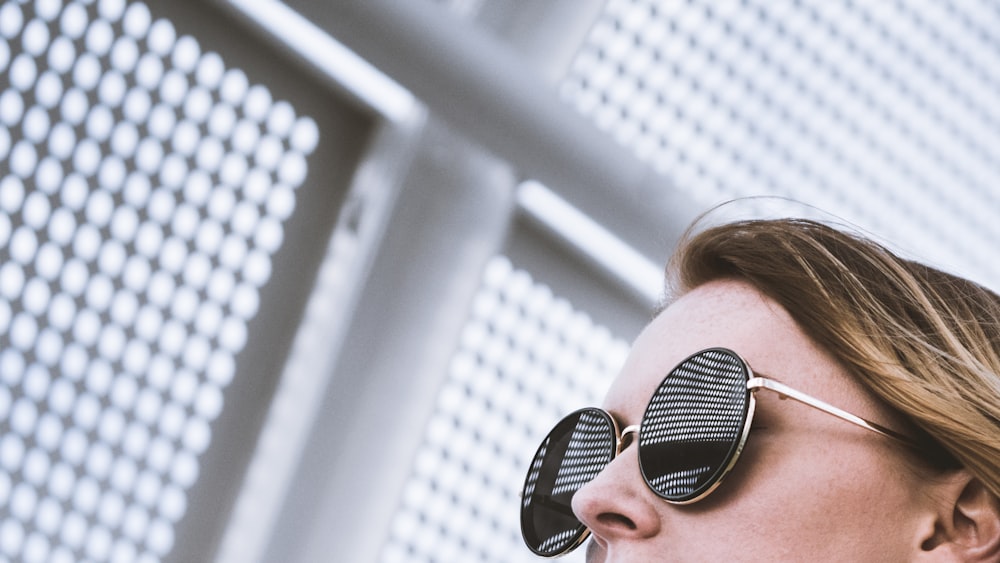 woman wearing round black sunglasses