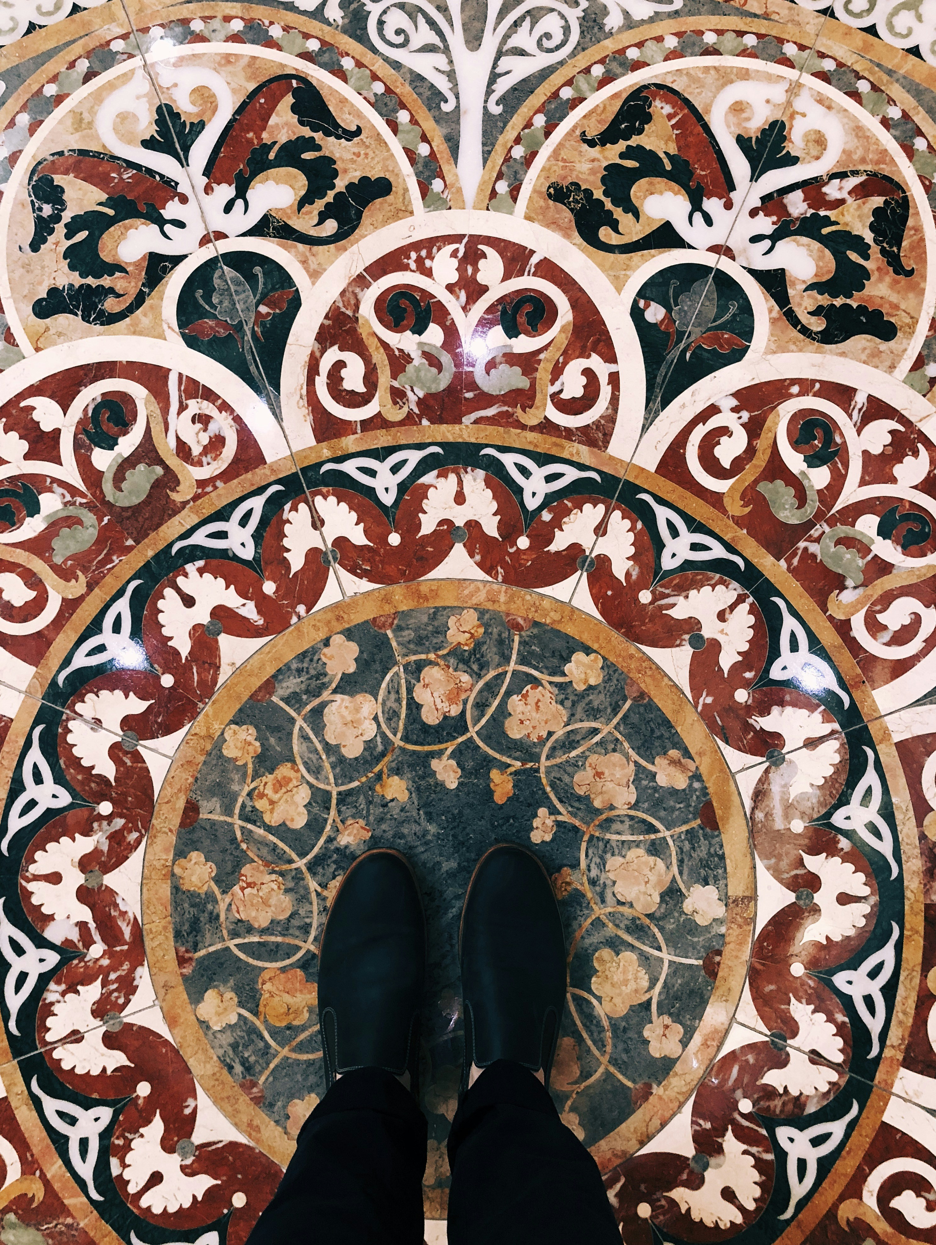 person wearing black slip-on shoes