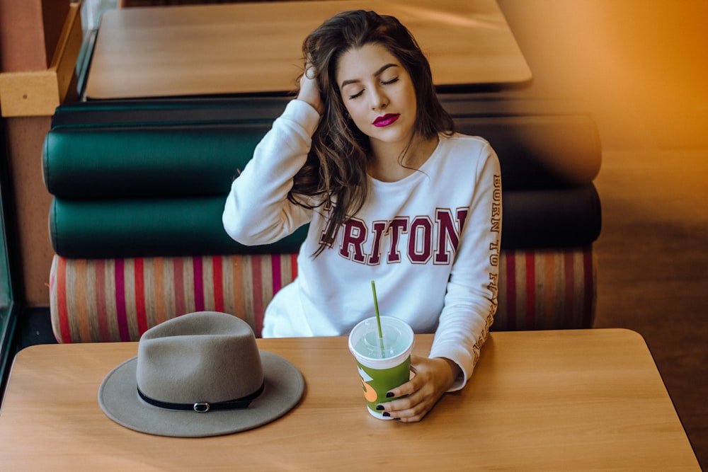 woman sitting on chair near table