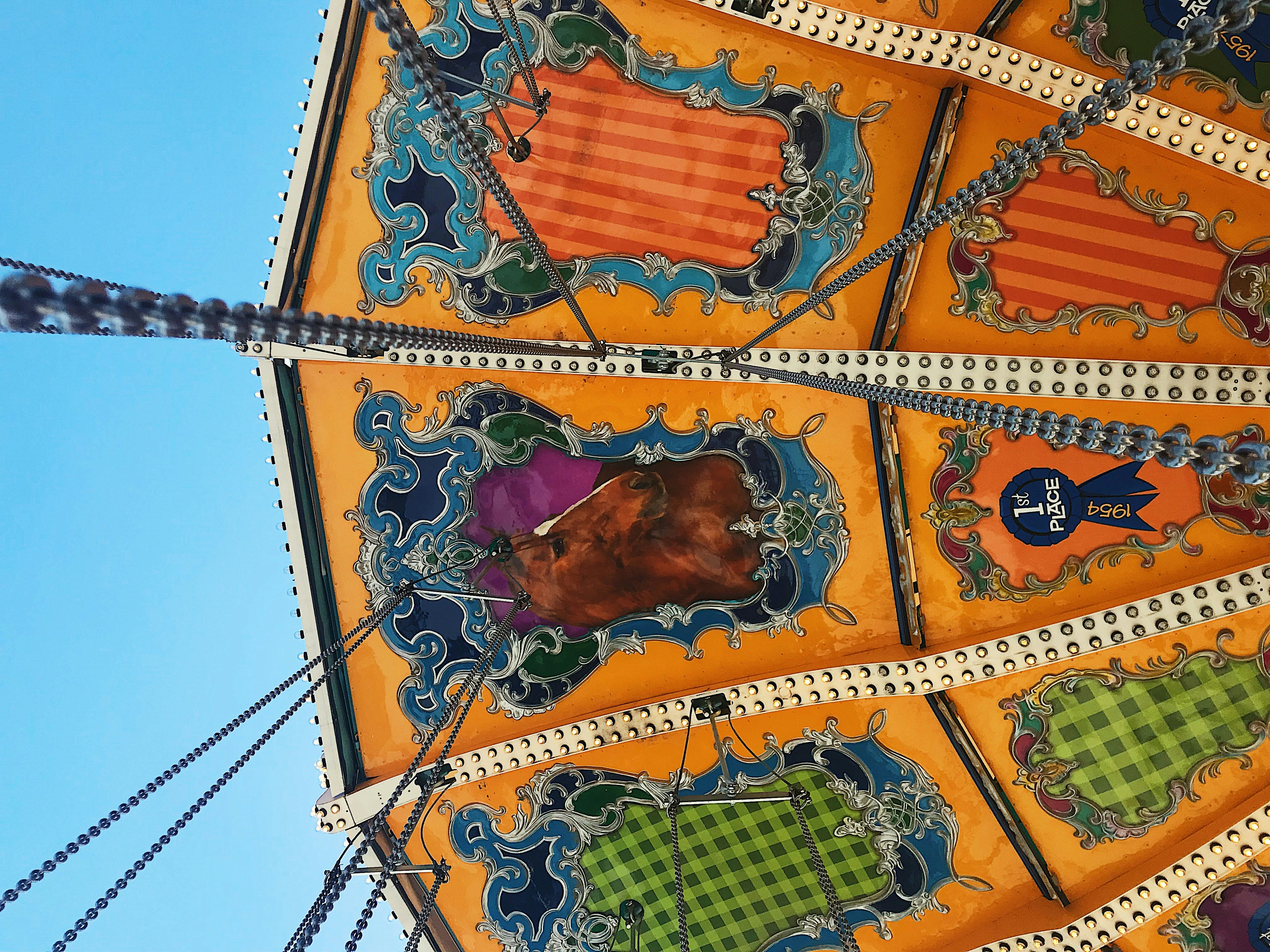 Un primo piano di una giostra di carnevale con un cielo blu sullo sfondo