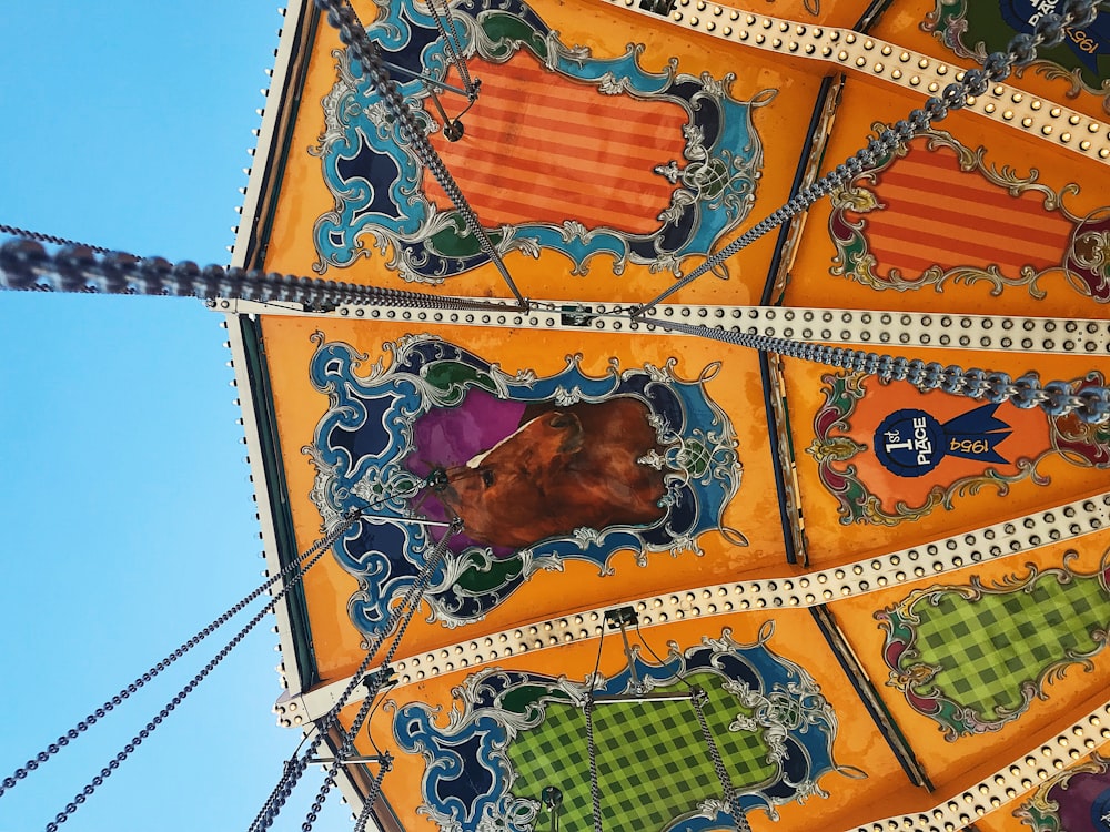 a close up of a carnival ride with a blue sky in the background