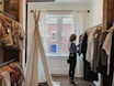 woman standing selecting clothes