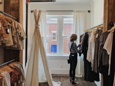 woman standing selecting clothes