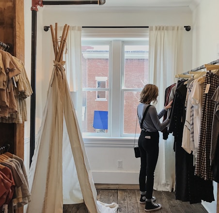 woman standing selecting clothes