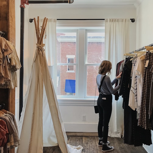 woman standing selecting clothes