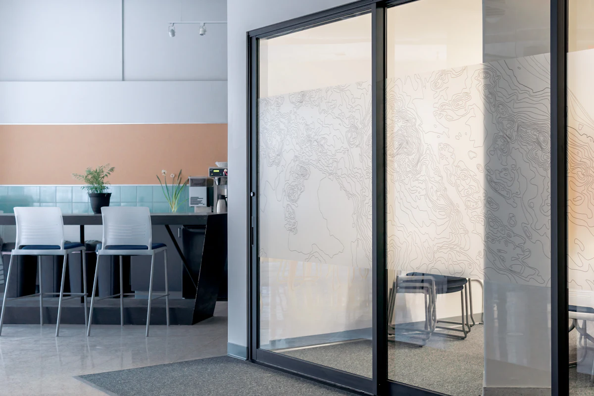 Sliding glass door running on its track in a modern space