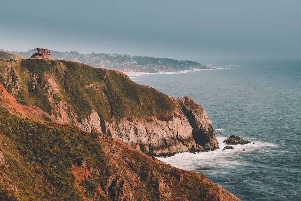 cliff over body of water during daytime