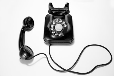 black rotary dial phone on white surface phone teams background