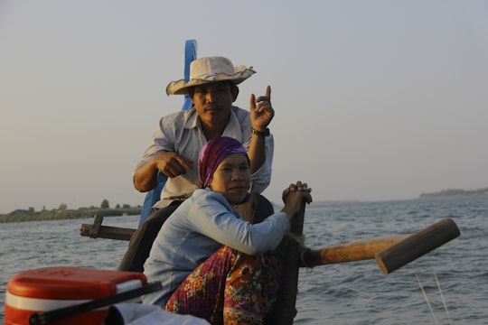 man and woman riding on boat in Phnom Penh Cambodia