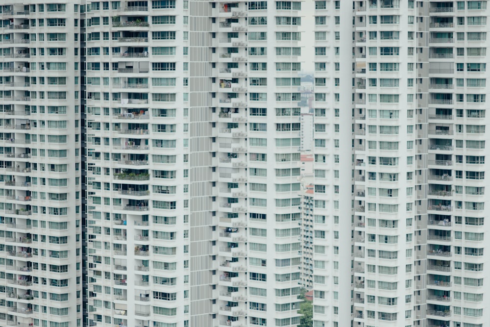 a couple of tall white buildings next to each other