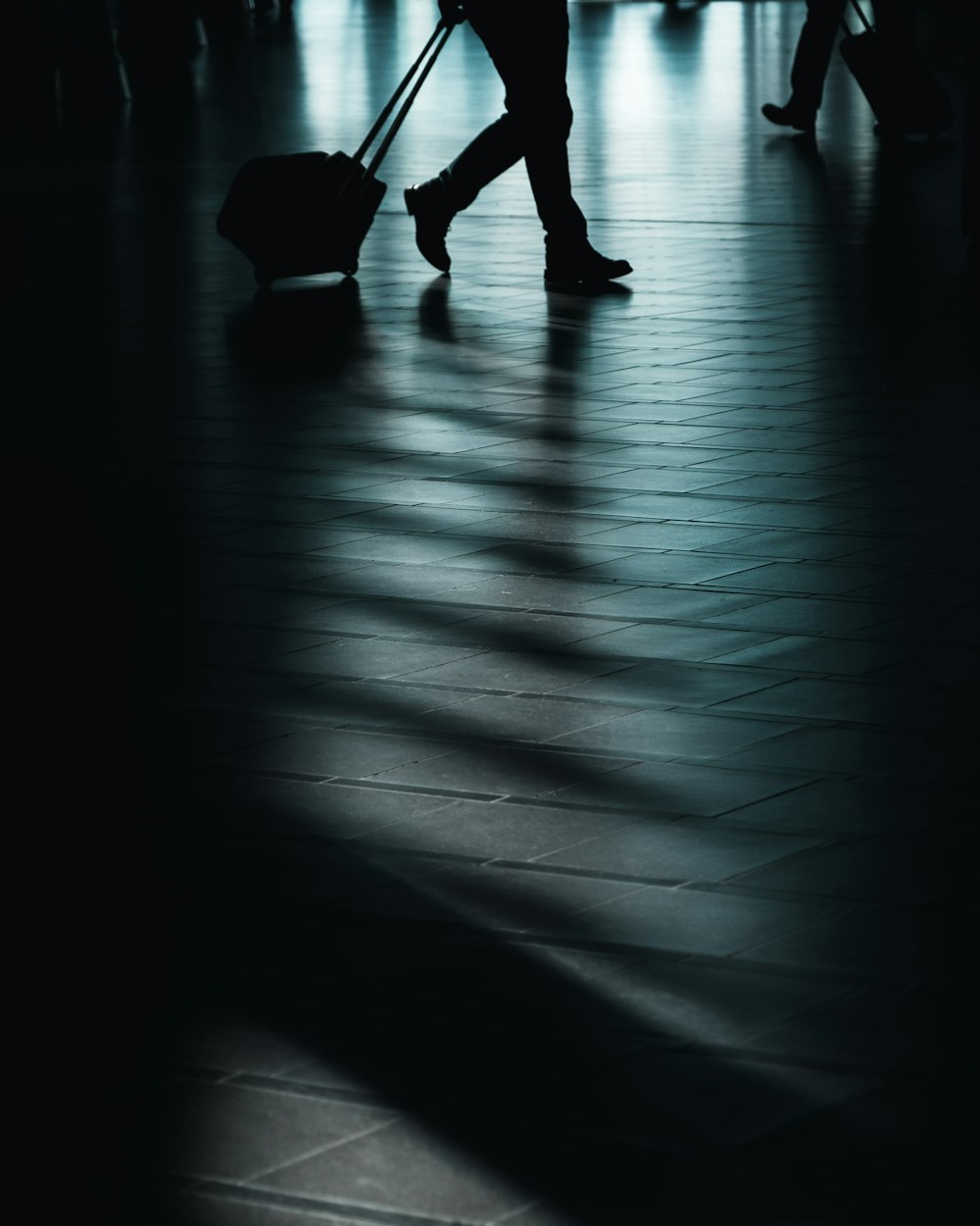 silhouette of man walking with luggage