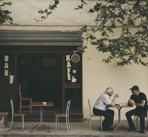 two man chatting white sitting on brown wooden chair