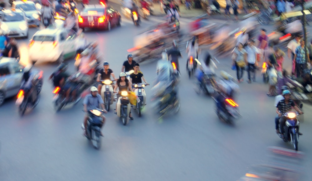a blurry photo of a busy street filled with motorcycles