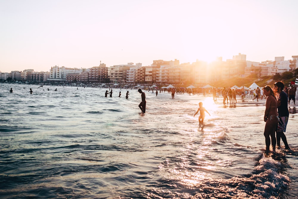 people standing near body of water at daytime