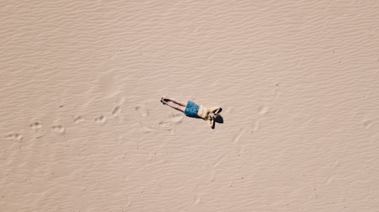 aerial photograph of man lying on sand in Tarifa Spain