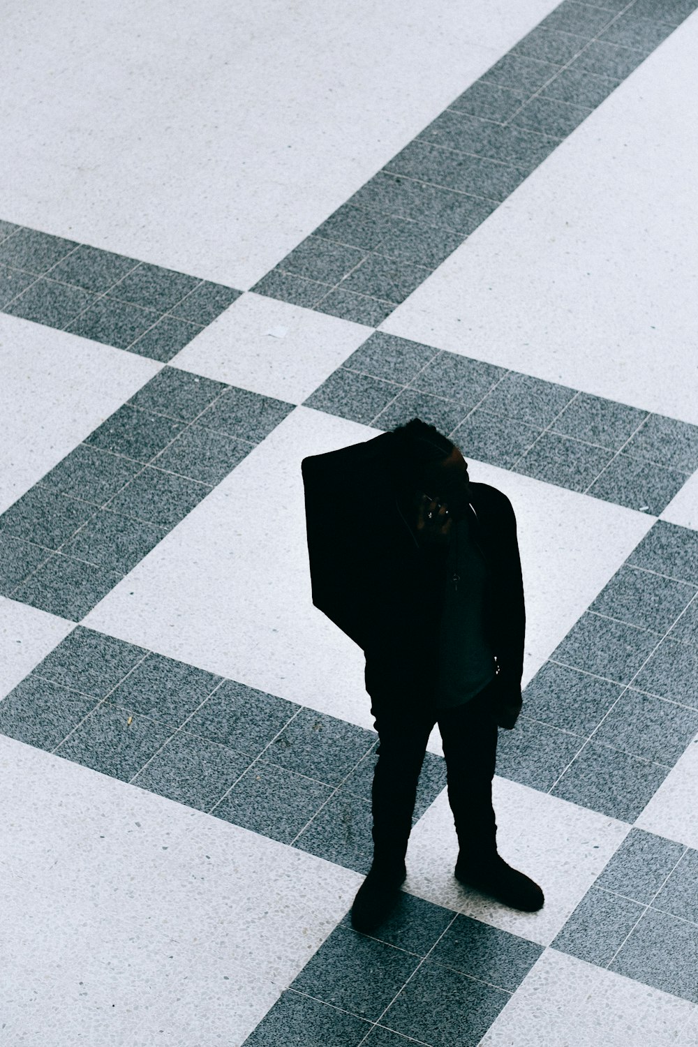 silhouette person walking on ceramic flooring