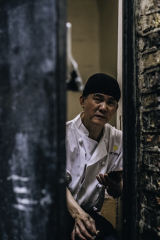 A portrait of the head chef in a modern kitchen.