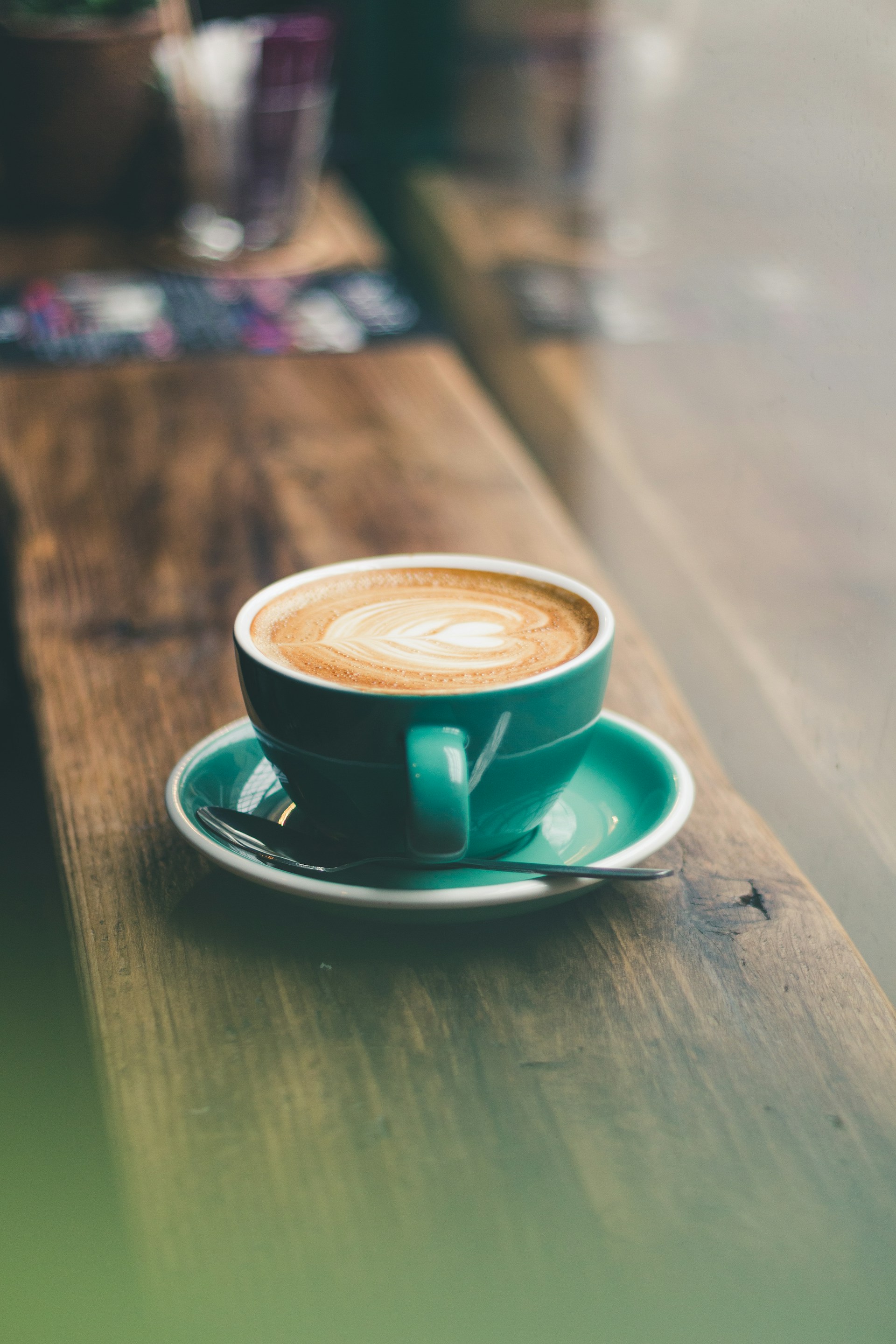 green ceramic cup on saucer