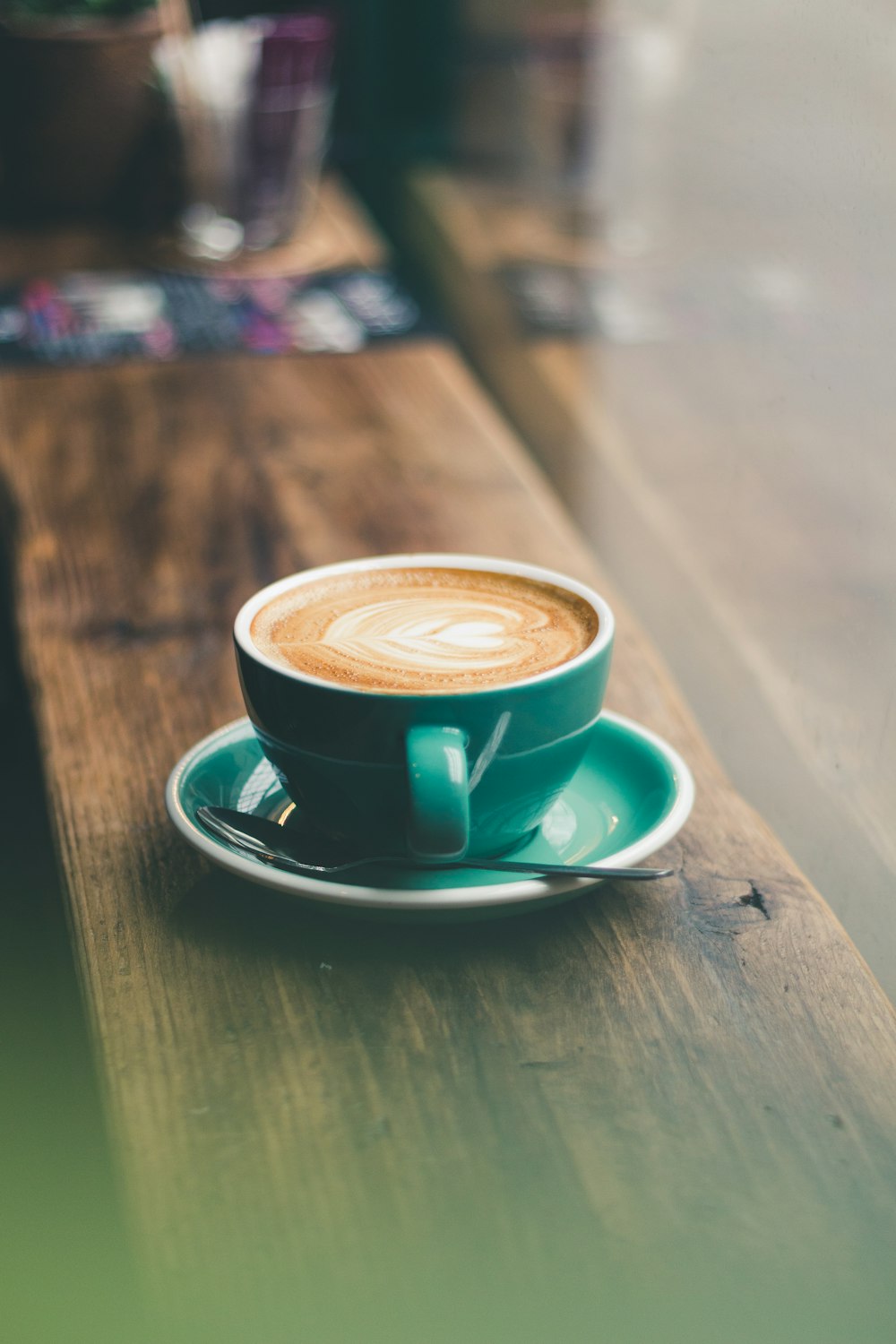 green ceramic cup on saucer