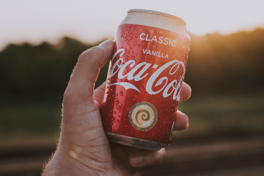 person holding Coca-Cola can