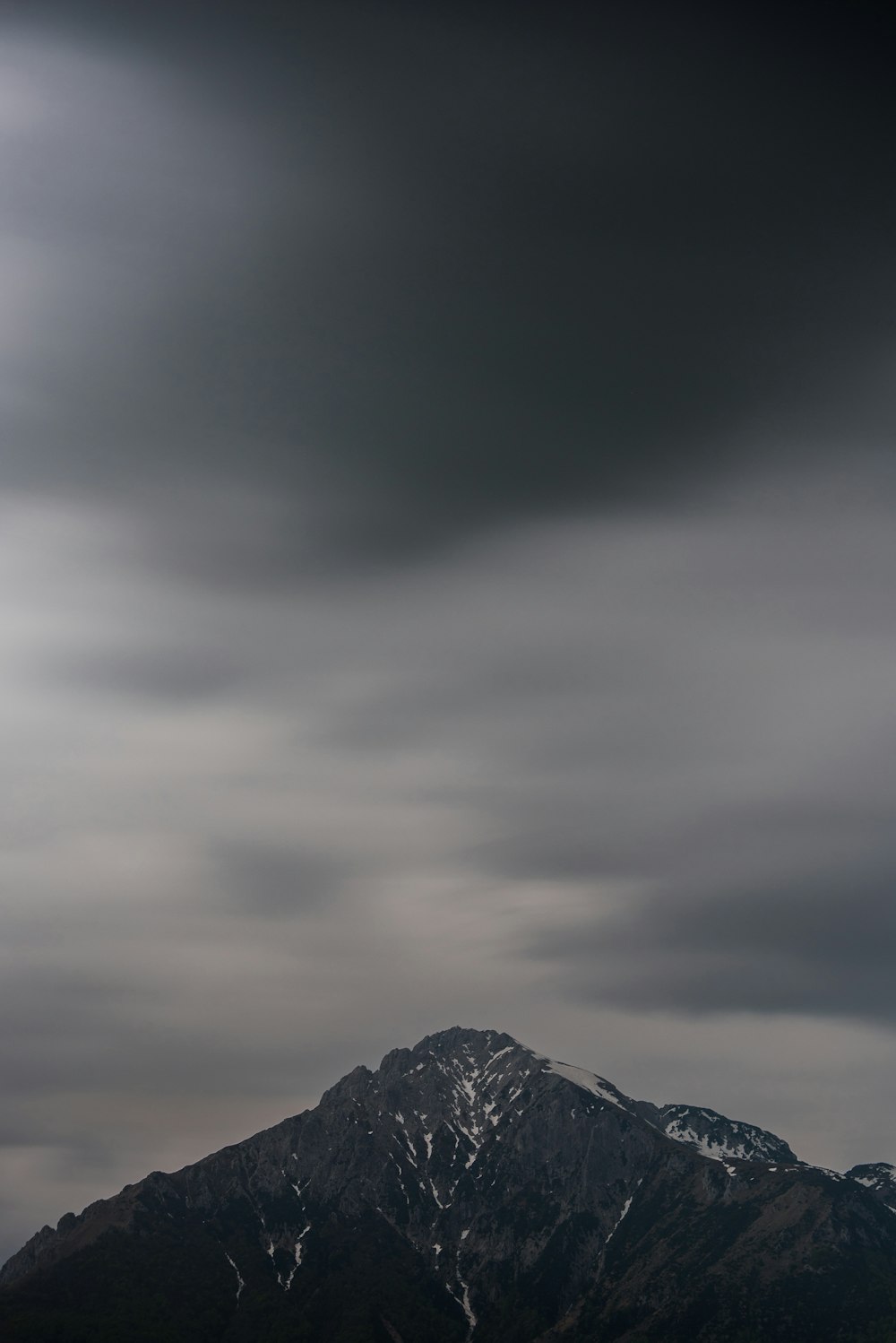 mountain range under gloomy sky