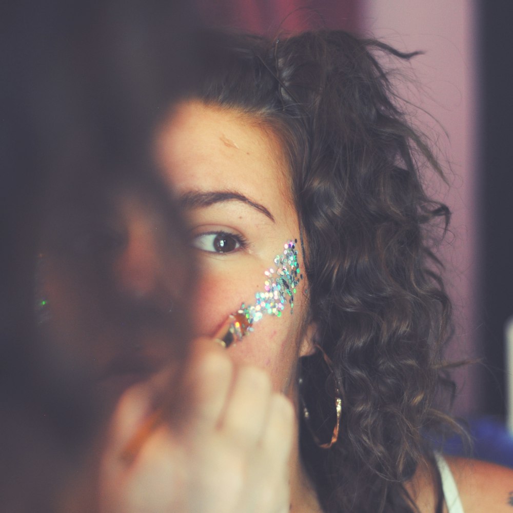 woman putting face paint