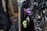 Various pendants and charms hang on black cords, including skull-shaped and ornate metallic designs. The focus is on a purple skull pendant, surrounded by intricate metallic figures and shapes.