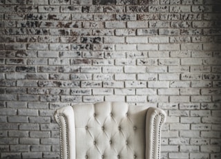 white flowers on top of white armchair