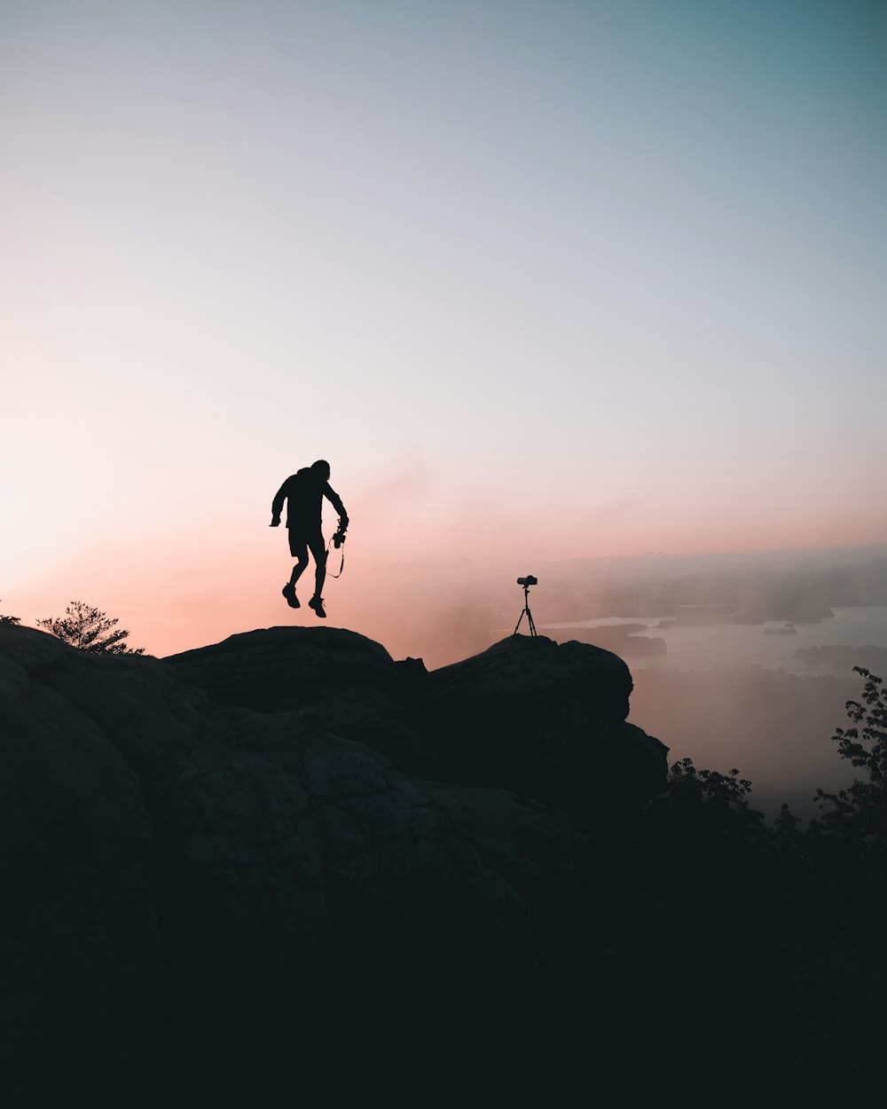 man jumping near cliff