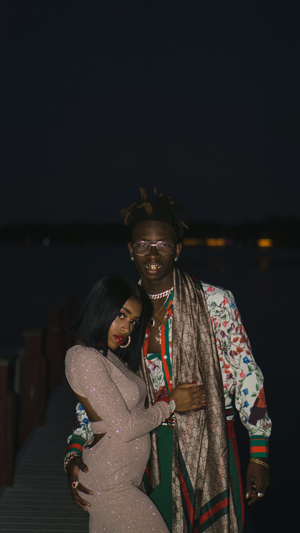 woman standing beside man during night time