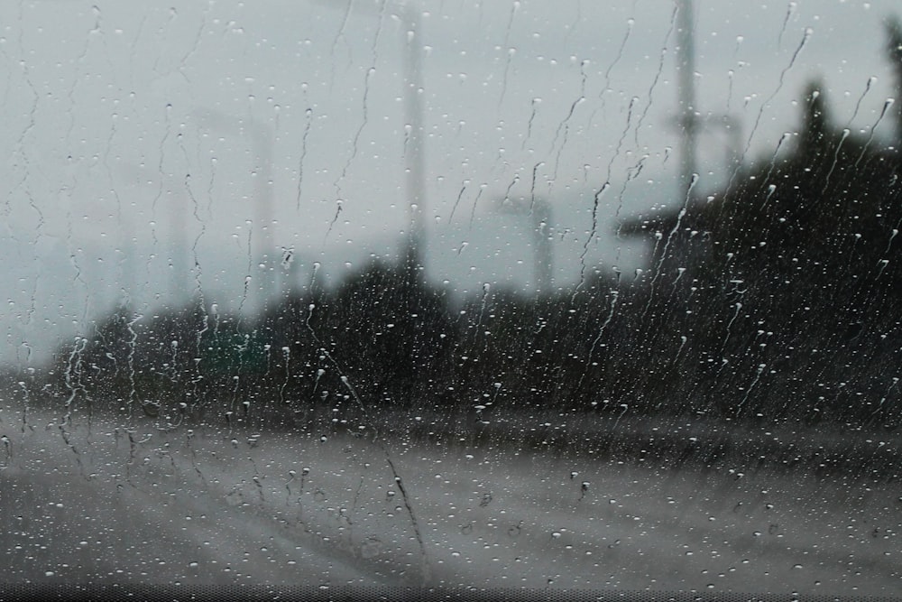 a view of a street through a rain covered window