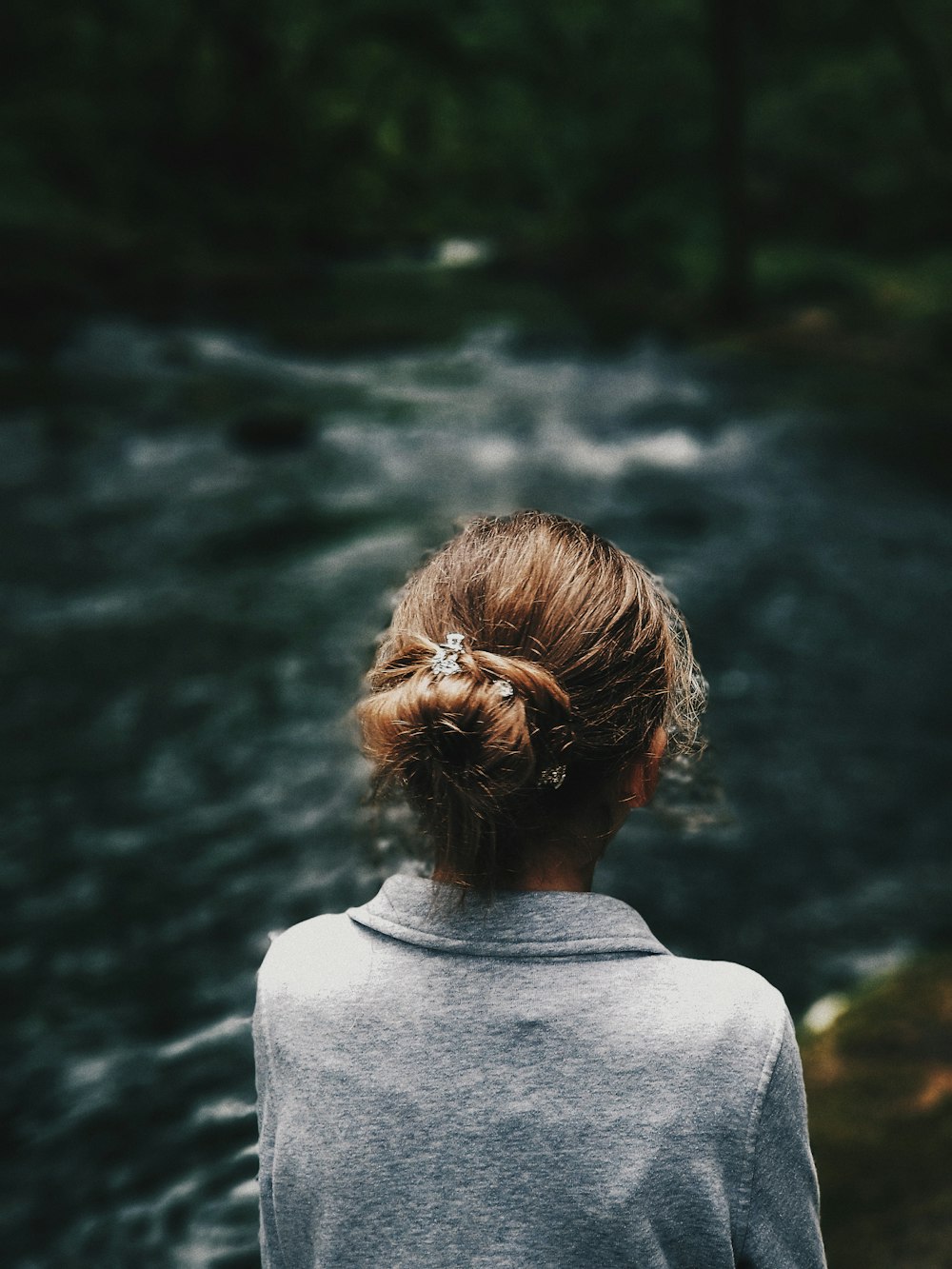 woman standing near at the river