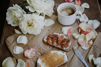 A cozy breakfast scene featuring Folivora spread on fresh bread next to a steaming cup of coffee.