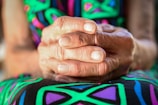 a close up of a person holding their hands together
