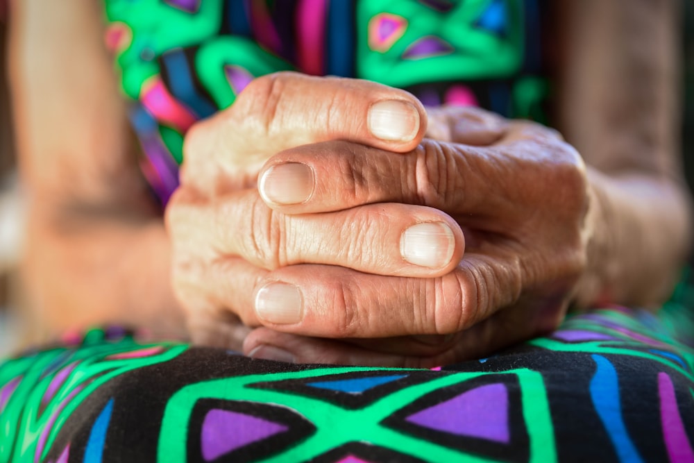 a close up of a person holding their hands together