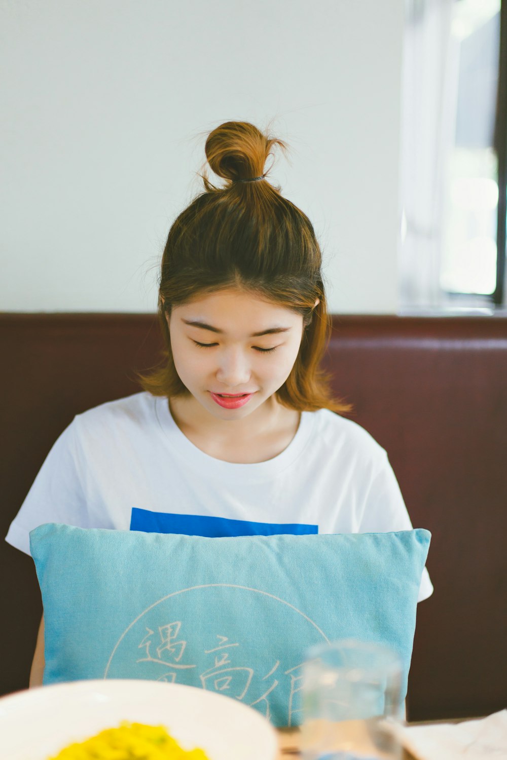 woman holding blue throw pillow