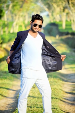 A man confidently wearing a korpa t-shirt outdoors on a sunny day.